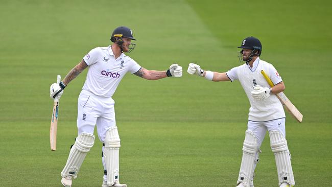 Ben Stokes (l) and Ben Duckett touch gloves during their century partnership. Picture: Getty