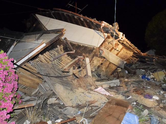 A house collapses following the earthquake in Mashiki, near Kumamoto city, southern Japan, early Friday, April 15, 2016. Rescuers in southern Japan are searching for trapped residents in at least two dozen collapsed houses, after a powerful earthquake struck. (Yuta Iida/Kyodo News via AP) JAPAN OUT, MANDATORY CREDIT