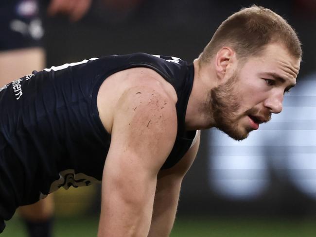 MELBOURNE, AUSTRALIA - JULY 21:  Harry McKay of the Blues is helped to his feet after a heavy collision during the round 19 AFL match between Carlton Blues and North Melbourne Kangaroos at Marvel Stadium, on July 21, 2024, in Melbourne, Australia. (Photo by Darrian Traynor/Getty Images)