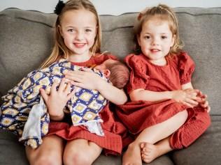 Paige, now 7, and Imogen, now 3, hold their little brother Darcy. Picture: Upon Our Days Photography