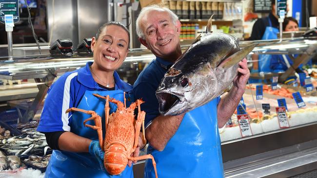 Anna Samiotis holds a South Australian crayfish while her father Jim Samiotis lifts a yellow fin tuna outside Prahran Seafoods. Picture: Josie Hayden