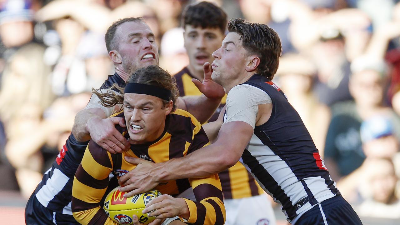 MELBOURNE, AUSTRALIA. April 7, 2024. AFL Gather Round. Round 4. Collingwood vs Hawthorn at the Adelaide Oval. Jack Ginnivan of the Hawks tackled by Patrick Lapinski and Tom Mitchell of the Magpies during the 1st qtr. . Pic: Michael Klein