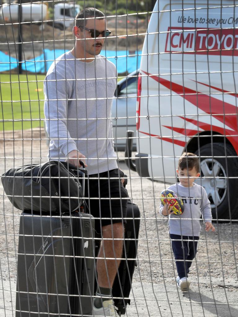 Taylor Walker and young son, Hugo, arrive with luggage at West Lakes. Picture: NCA NewsWire/Dean Martin