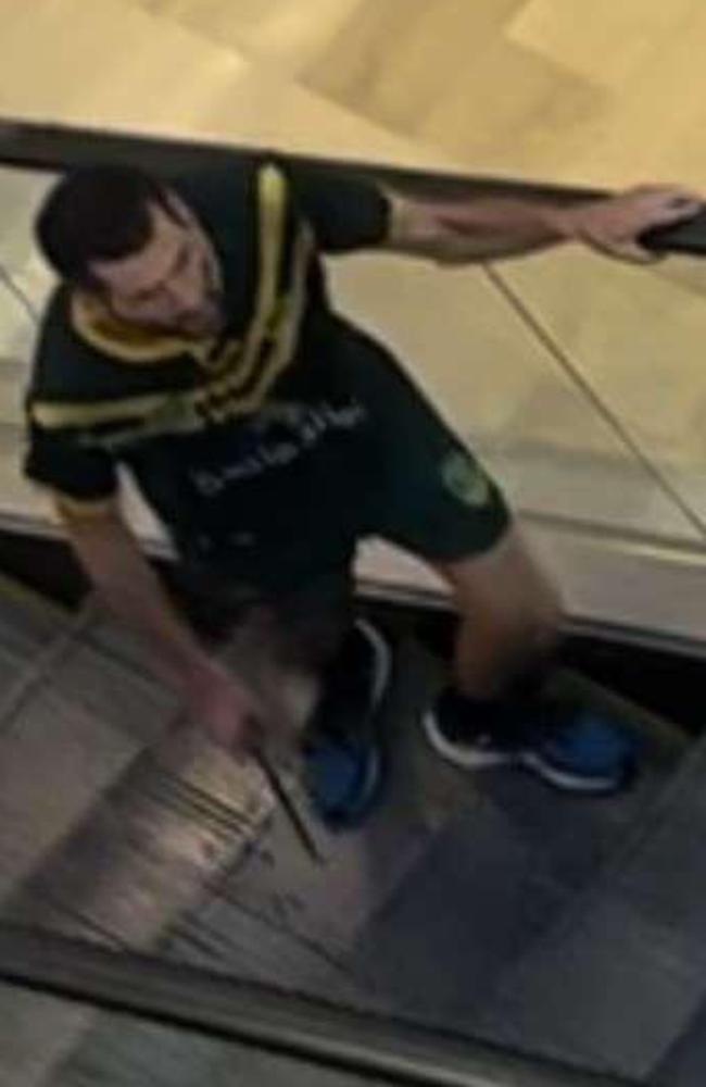 The killer dressed in a Kangaroos jersey seen on an escalator in Westfield Bondi Junction. Picture: Twitter