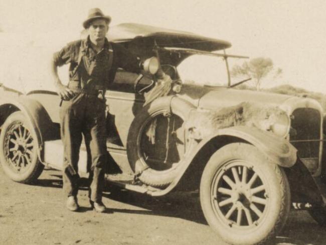 “Snowy” Rowles stands beside James Ryan’s Dodge, taken by Arthur Upfield. Picture: National Library of Australia