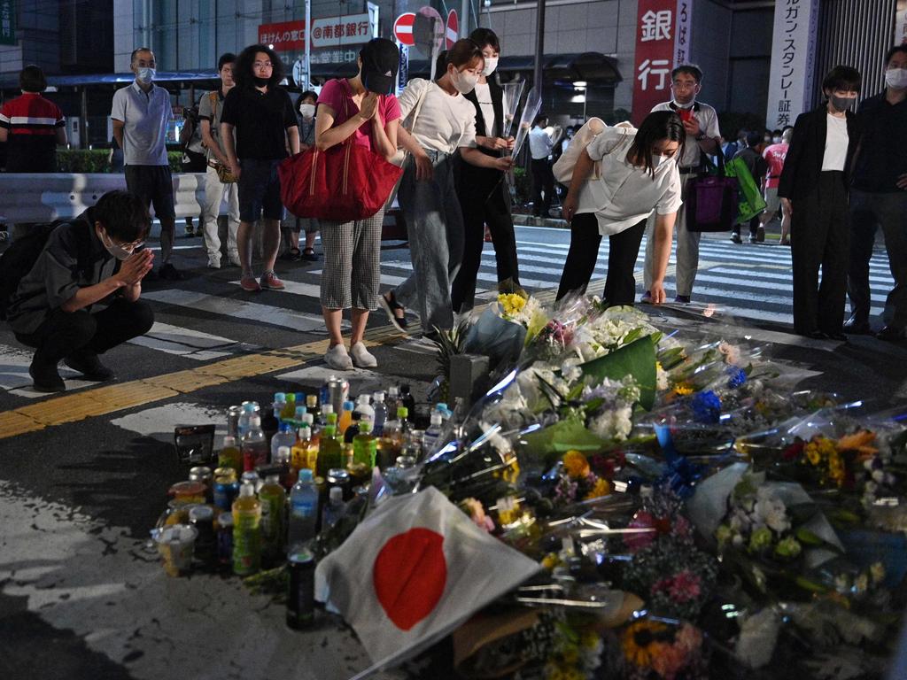 People pay their respects in front of a makeshift memorial outside Yamato-Saidaiji Station, where former Japanese prime minister Shinzo Abe was shot. Picture: AFP