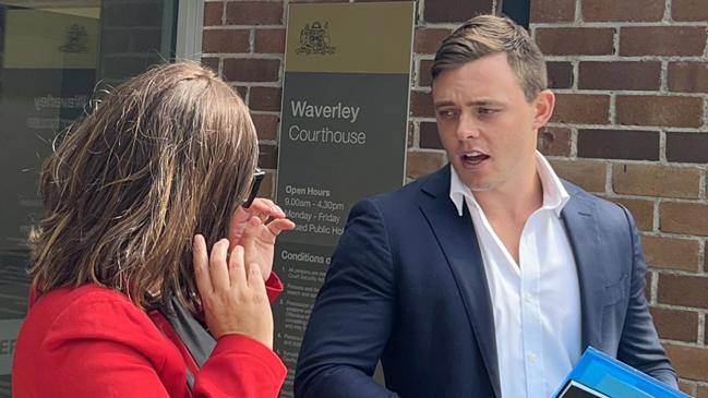 Hamish Dowling speaking to his lawyer outside Waverley Local Court on Wednesday.