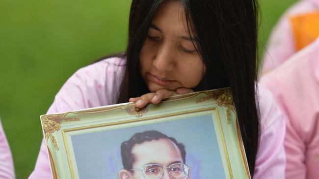 A Thai woman holds a portrait of KingBhumibol Adulyadej as she prays for his health. Picture: AFP/Munir Uz Zaman