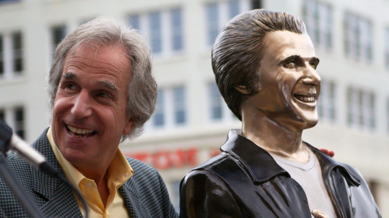 Actor Henry Winkler, left, poses with a bronze statue of the <i>Happy Days</i> character he portrayed, Arthur Fonzarelli, also known as The Fonz in 2008, in Milwaukee. The program, which ran from 1974-1984, was based in Milwaukee. Picture: AP Photo/Carrie Antlfinger