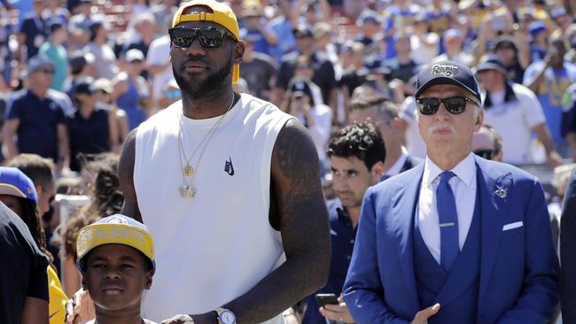 LeBron James, left, of the Cleveland Cavaliers, stands next to Los Angeles Rams owner Stan Kroenke prior to an NFL football game between the Rams and the Seattle Seahawks.