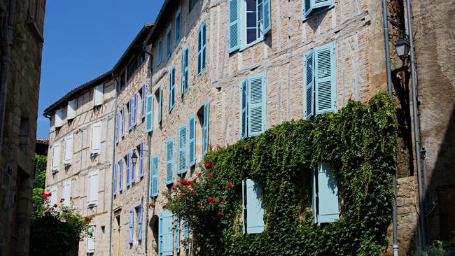 Colourful window shutters in Figeac.