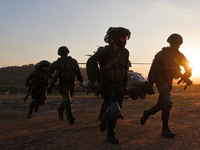 Israeli soldiers take part in a rescue exercise in Upper Galilee near the Lebanon border on February 7, 2024, amid ongoing battles between Israel and Palestinian Hamas militants in the Gaza Strip. (Photo by jalaa marey / AFP)