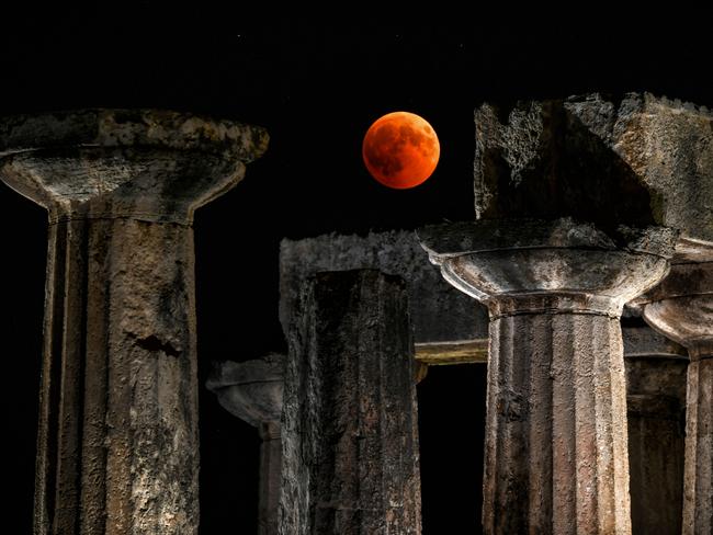 A picture shows the full moon during a "blood moon" eclipse over the temple of Apollo in Corinth. Picture: AFP