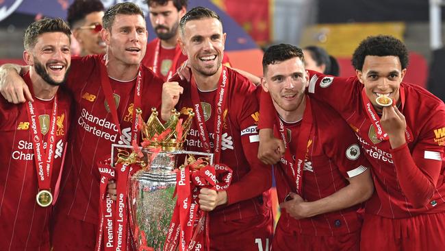 Adam Lallana, James Milner, Jordan Henderson, Andrew Robertson and Trent Alexander-Arnold pose with the Premier League trophy. Picture: AFP