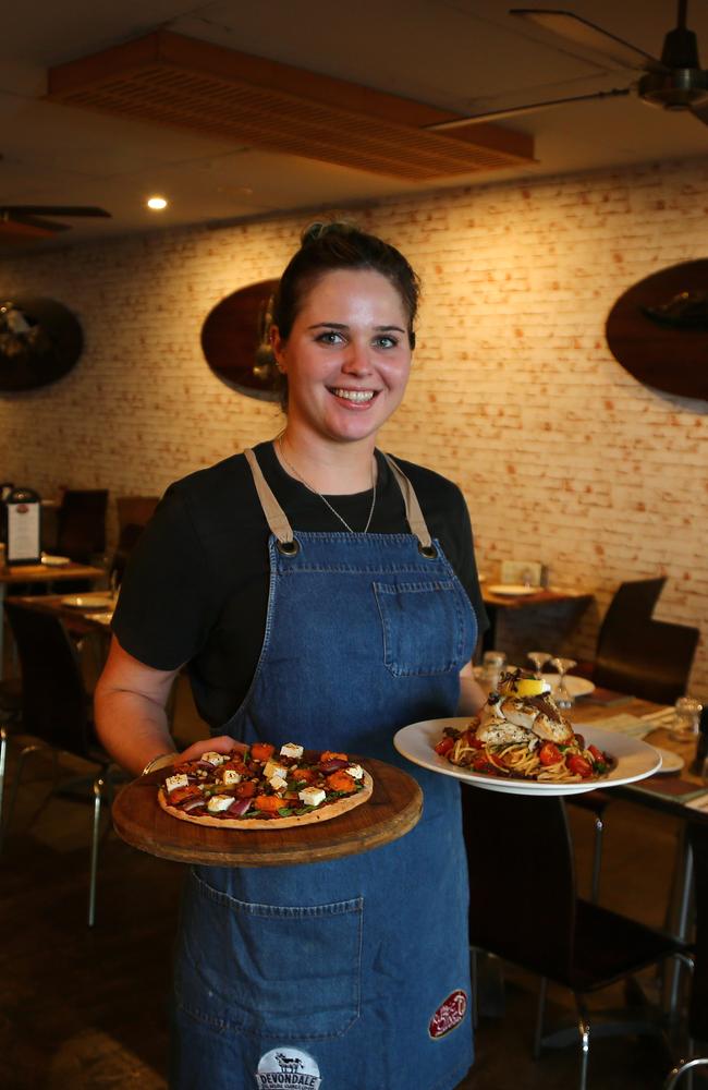 Emily Clooney carries a donatello pizza and spaghetti anchovies with barramundi fillet. Picture: AAP Image/David Clark.