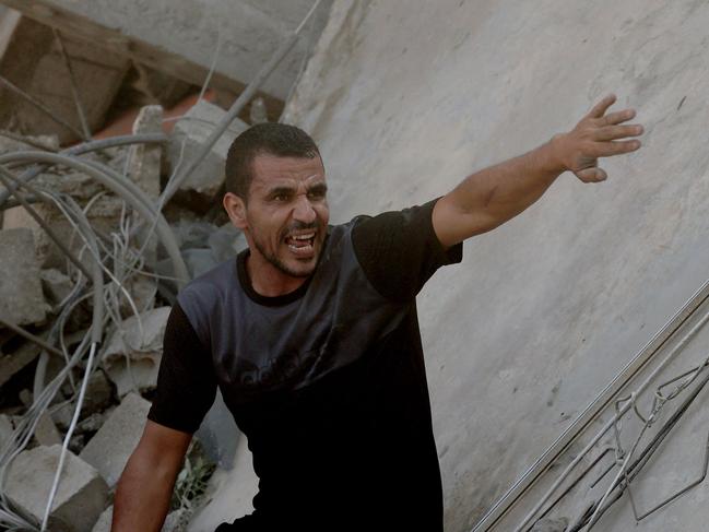 A Palestinian man reacts as he stands on a collapsed home following an Israeli air strike in Rafah, in the southern Gaza Strip. Picture: AFP