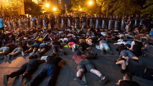 Protesters lay down facing a police line in front of the White House during protests over the death of George Floyd in Washington, DC. Picture: AFP