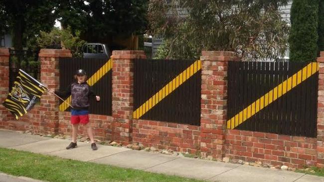 Luke Martin in front of his Tiger-themed Chelsea fence. Picture: Supplied