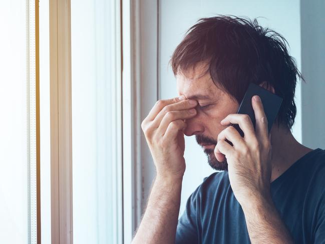 Phone call, generic, worried, anxious man talking with someone on mobile phone.