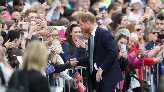 Prince Harry shakes hands with a fan. Picture: AAP