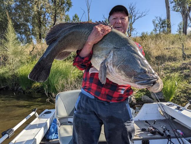 Robert Styan shows off his "monster fish", estimated to be 40kg, caught off the Glenlyon Dam Holiday Cottage.