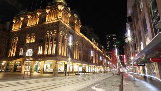 The lights are on, but no one is at home in George Street and the QVB building in Sydney’s CBD. Picture: Damian Shaw