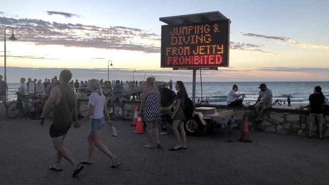 A new sign warning that jetty jumping is banned at Glenelg. Picture: Eugene Boisvert