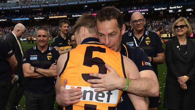 Hawthorn player Sam Mitchell (left) and coach Alastair Clarkson react after winning the 2015 premiership. Picture: Julian Smith