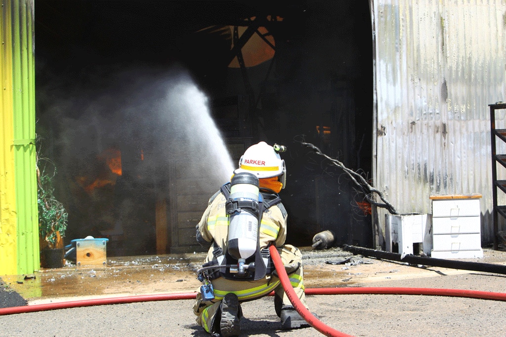 A firefighter at the scene of a Drayton business fire today. Picture: Paul Ellison