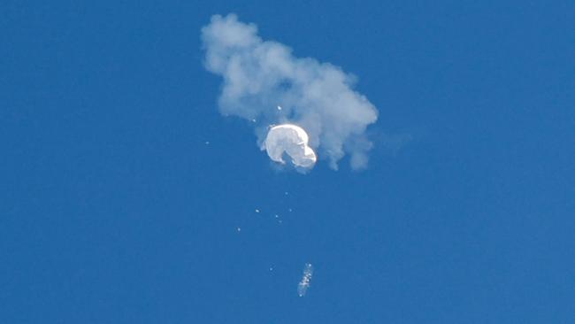 The Chinese balloon disintergrates into a white puff after being hit with a single missile from a US F-22 Raptor fighter-bomber off the coast of South Carolina on Saturday. Picture: Reuters