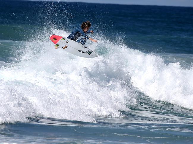 Surfers took to the water to enjoy the swell on Sunday. Photo: David Clark