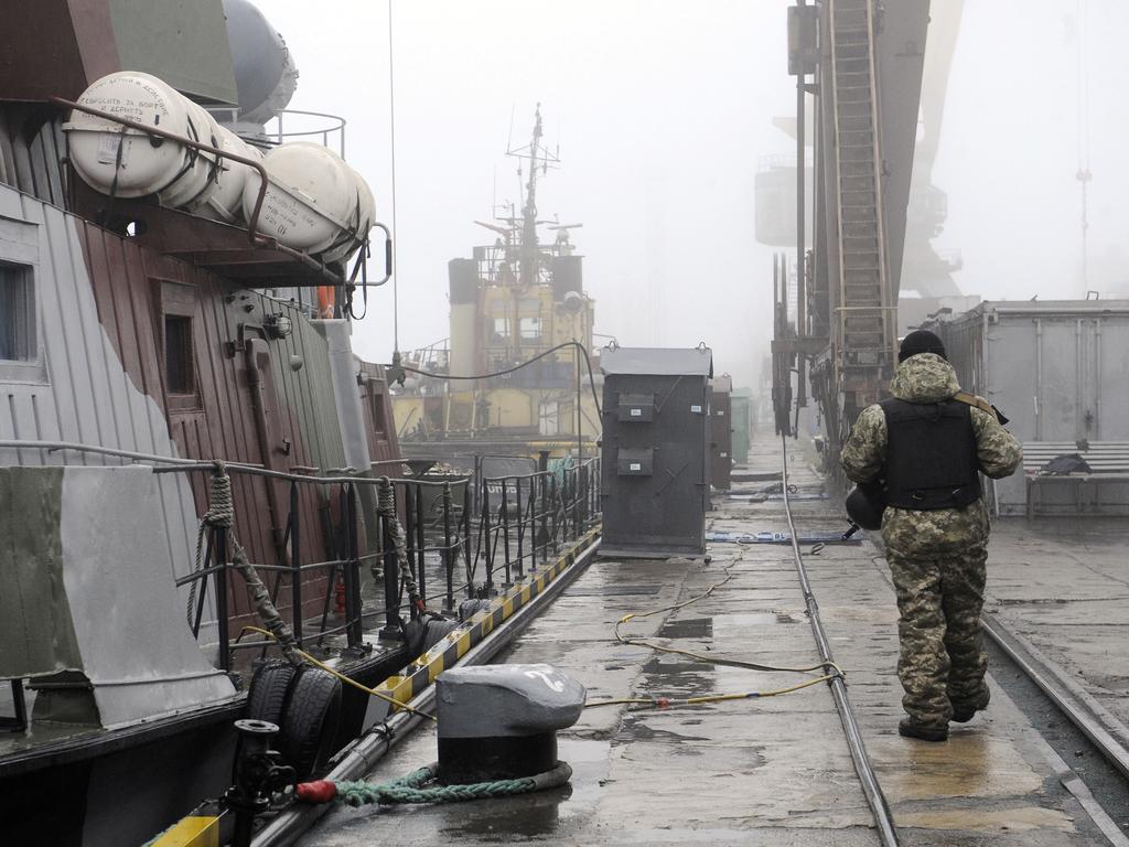 A soldier patrols next to a Ukrainian military boat. Picture: AFP
