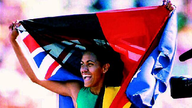 Cathy Freeman draped in Aboriginal and Australian flags after winning 400m at the 1994 Commonwealth Games.