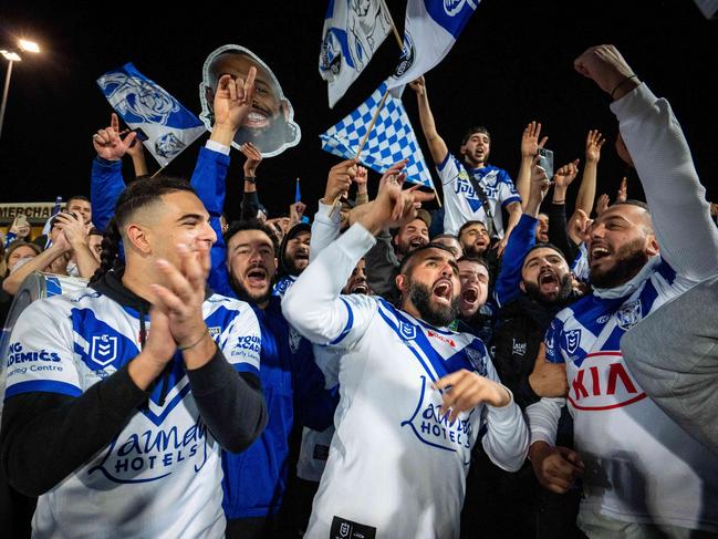 Bulldogs fans celebrate their teams win over the Dragons at Jubilee oval on Saturday night.Photo: Tom Parrish