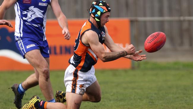 EDFL: Burnside Heights’ Sebastian Gatherer fires off a handball. Picture: Hamish Blair