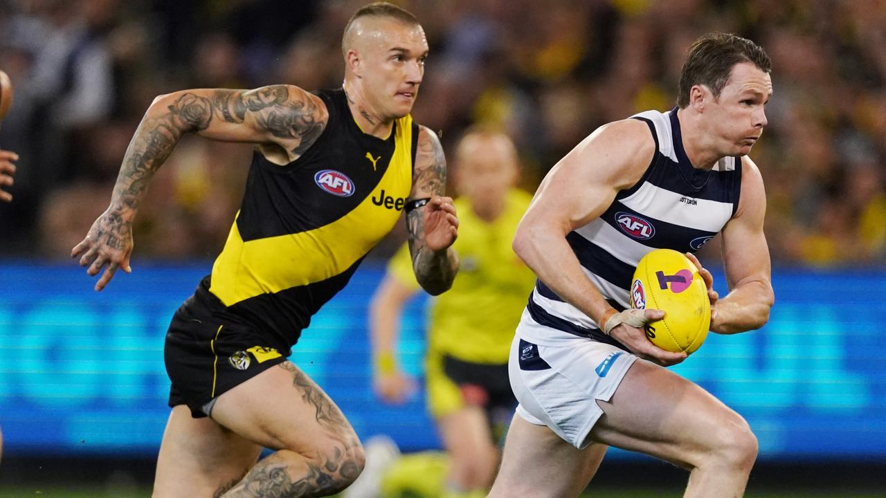 Patrick Dangerfield motors away from Dustin Martin at the MCG.