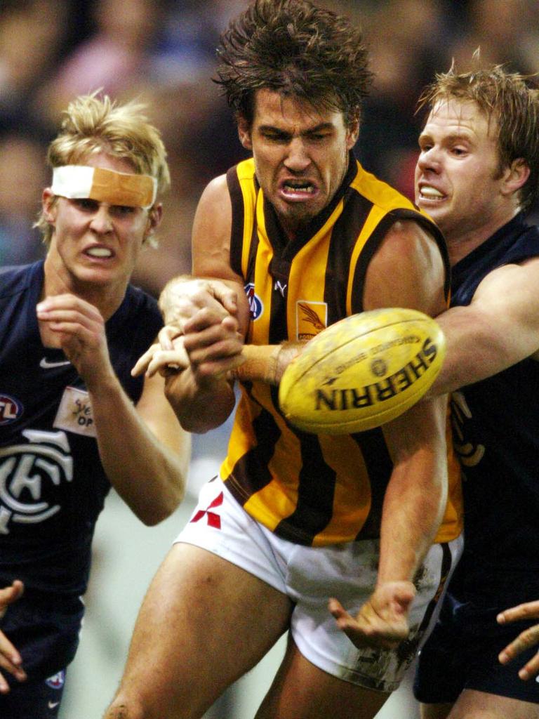 Nathan Thompson cops heat from two Blues in 2004.