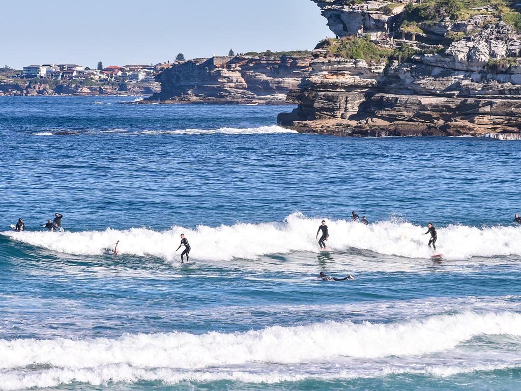 Surfers take to the waves on Bondi Beach. Picture: NCA NewsWire / Flavio Brancaleone