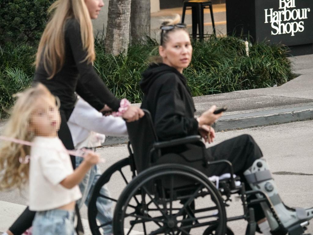 Anna Kournikova is seen sporting a leg brace while riding in a wheelchair during a family shopping session in Bal Harbour. Anna retired from professional tennis in 2003. Picture: BACKGRID