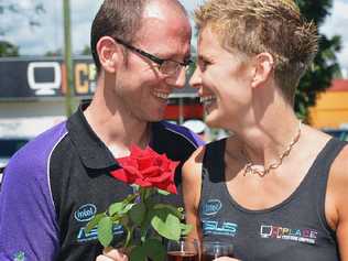 TRUE LOVE: PC Place owners Nick and Gemma Green take time out from their business to smell the roses in Memorial Park. Picture: Greg Miller