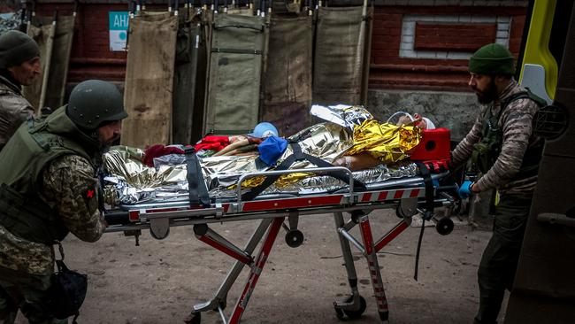 Volunteer medics from PDMSh (The First Volunteer Mobile Hospital) evacuate a wounded Ukrainian soldier from Bakhmut. Picture: AFP