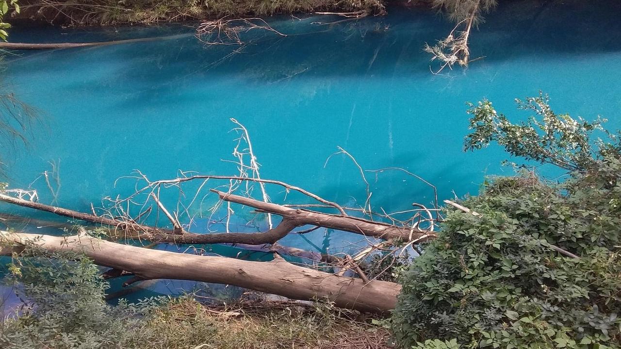 The colour of the creek was a vivid teal.