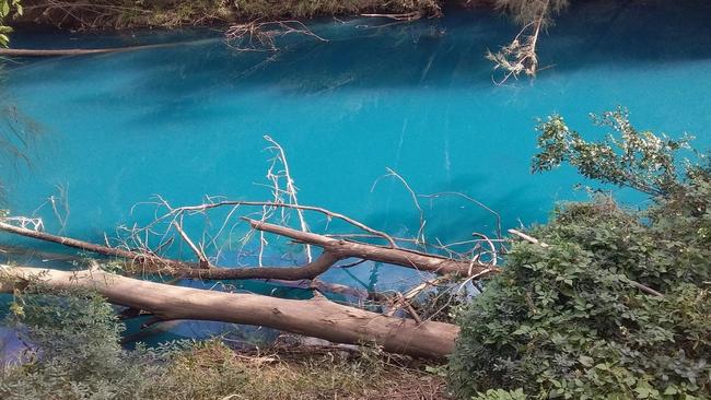 The colour of the creek was a vivid teal.