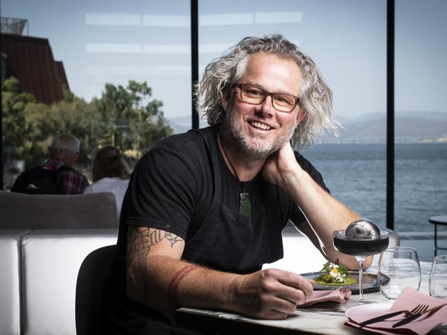 Executive Chef of Mona Vince Trim pictured at Faro restaurant with a scallop taco and black margarita with pig's eye. Picture: LUKE BOWDEN