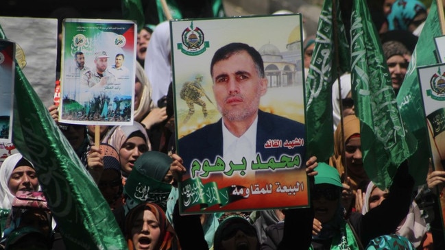 People carried a portrait of Mohammed Deif, commander of the armed wing of Hamas, during a demonstration in the West Bank in 2014. Picture: APA Images/Zuma Press/WSJ