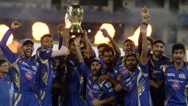 Mumbai Indians players hold the trophy aloft after pulling off the incredible comeback win.