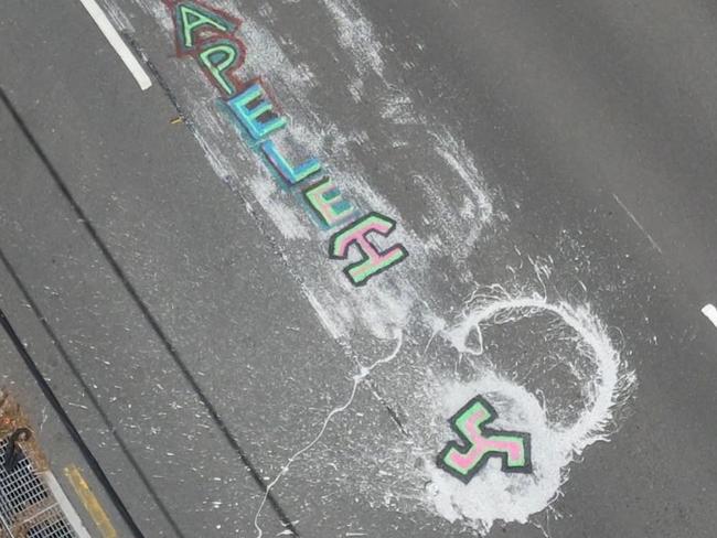 The graffiti daubed on the roadway. Picture: TNV