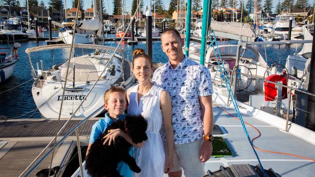 Natalie Feil and Ben Morgan, with their son Edison next to their yacht at 35 South Marina. Pic: Serena Findlay