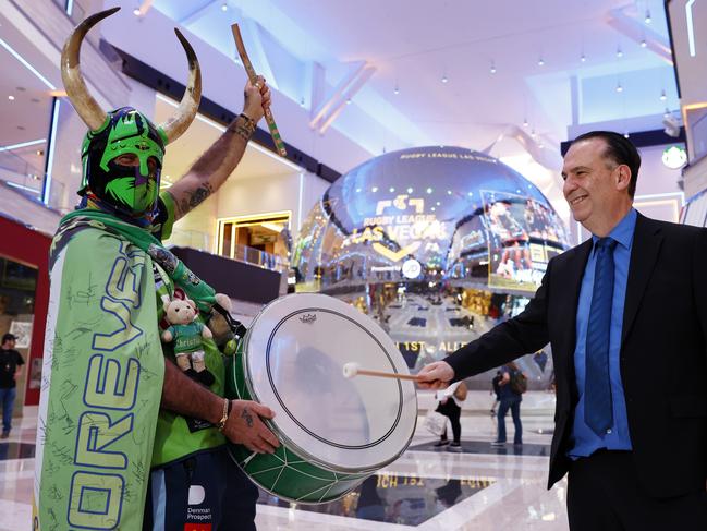 Peter V'landys banging the drum of Raiders fan Simon Tayoun at the Las Vegas Week Media Launch at the NRL Fan Hub at Resorts World. Picture: Jonathan Ng