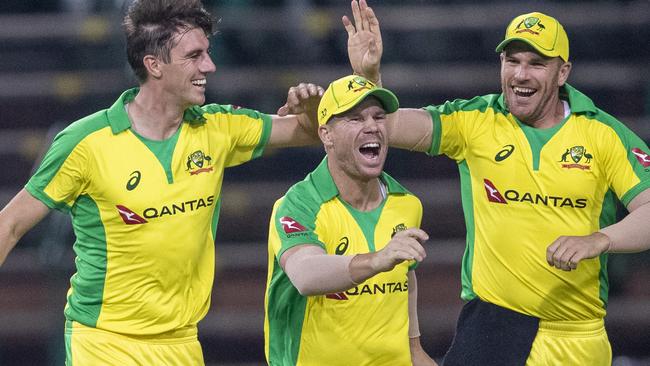 Australia's bowler Pat Cummins, left, celebrates with teammates David Warner, middle, and captain Aaron Finch after dismissing South Africa's batsman David Miller during the 1st T20 cricket match between South Africa and Australia at Wanderers stadium in Johannesburg, South Africa, Friday, Feb. 21, 2020. (AP Photo/Themba Hadebe)